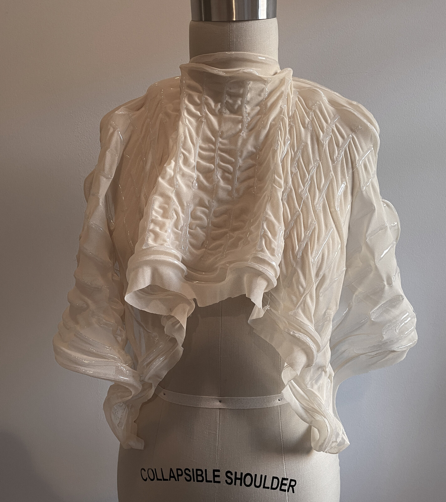 Gathered bolero with warp texture on dress form